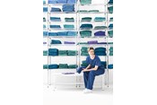 female nurse wearing Barrier a scrub suit enters a room
