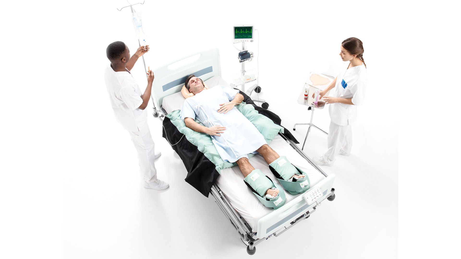 two clinicians and a patient on a turning and positioning system